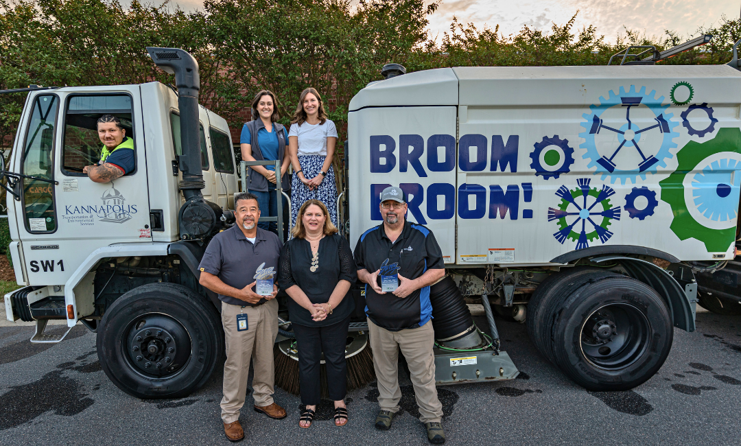 Savvy winners in front of leaf vacuum truck Savvy winners in front of leaf vacuum truck